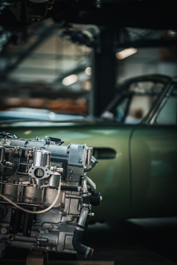 Newly restored engine for a classic car in a background stored in a vintage car restauration garage.